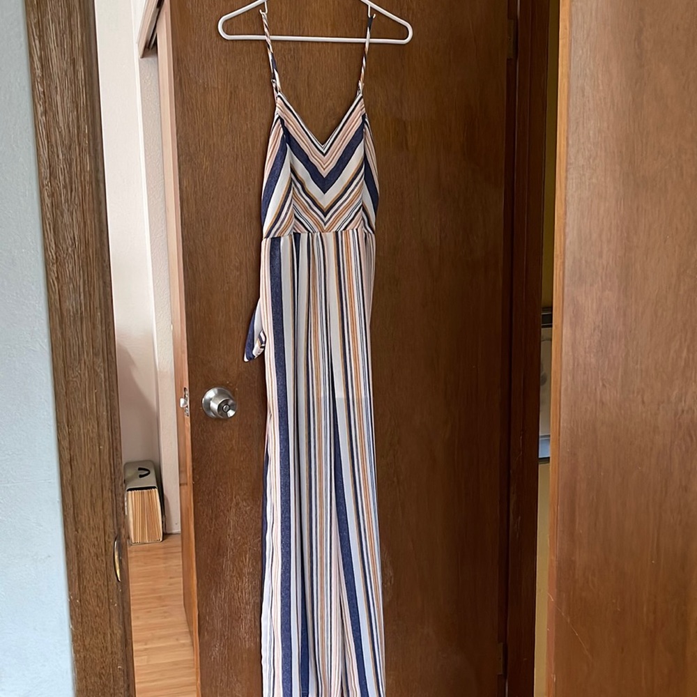 Striped and the colors are navy, golden yellow, blush pink and cream.
